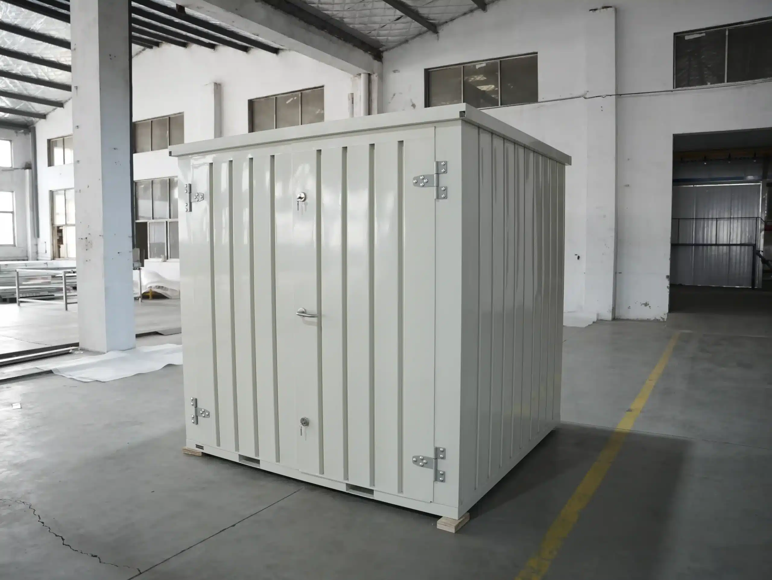 Compact flat-pack jobsite storage container inside an industrial facility