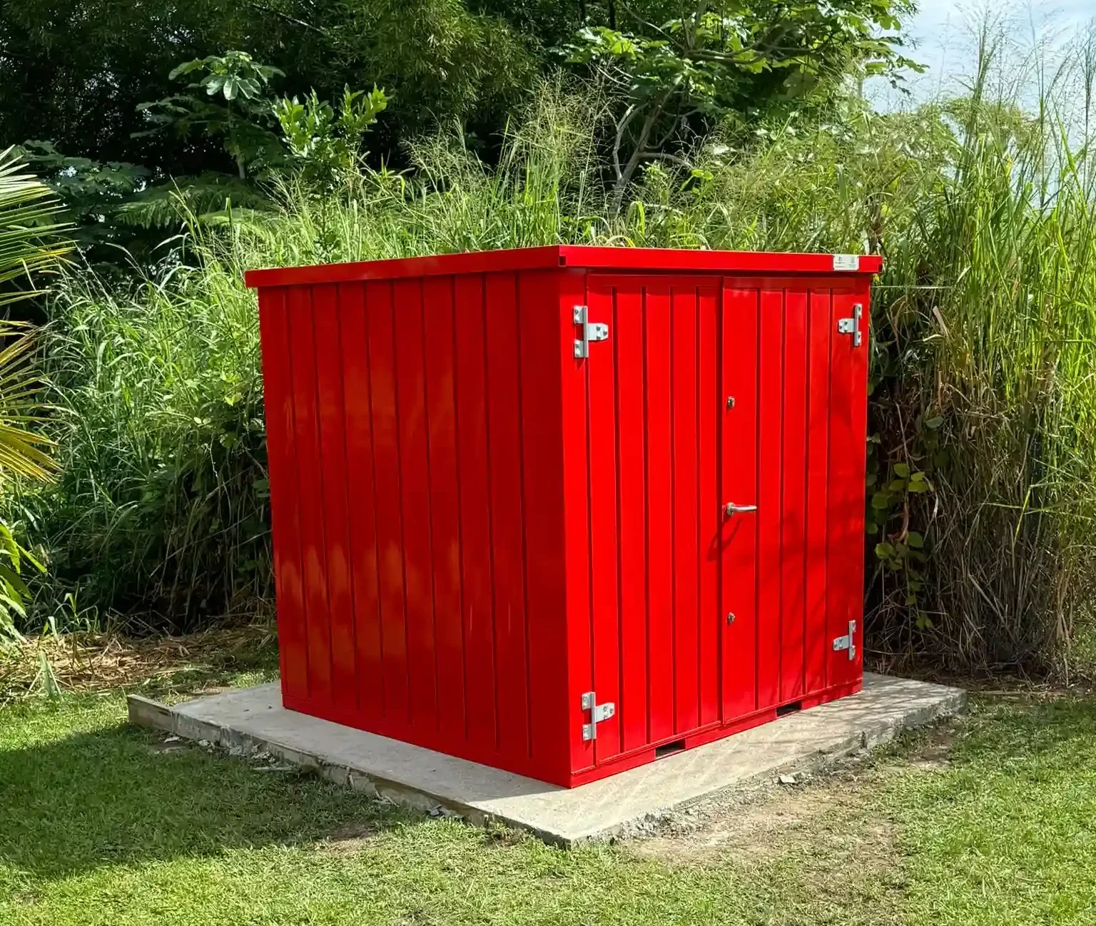 Red portable storage container placed outdoors on a property site