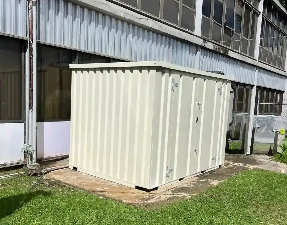 Standard flat-pack jobsite storage box placed beside a commercial building