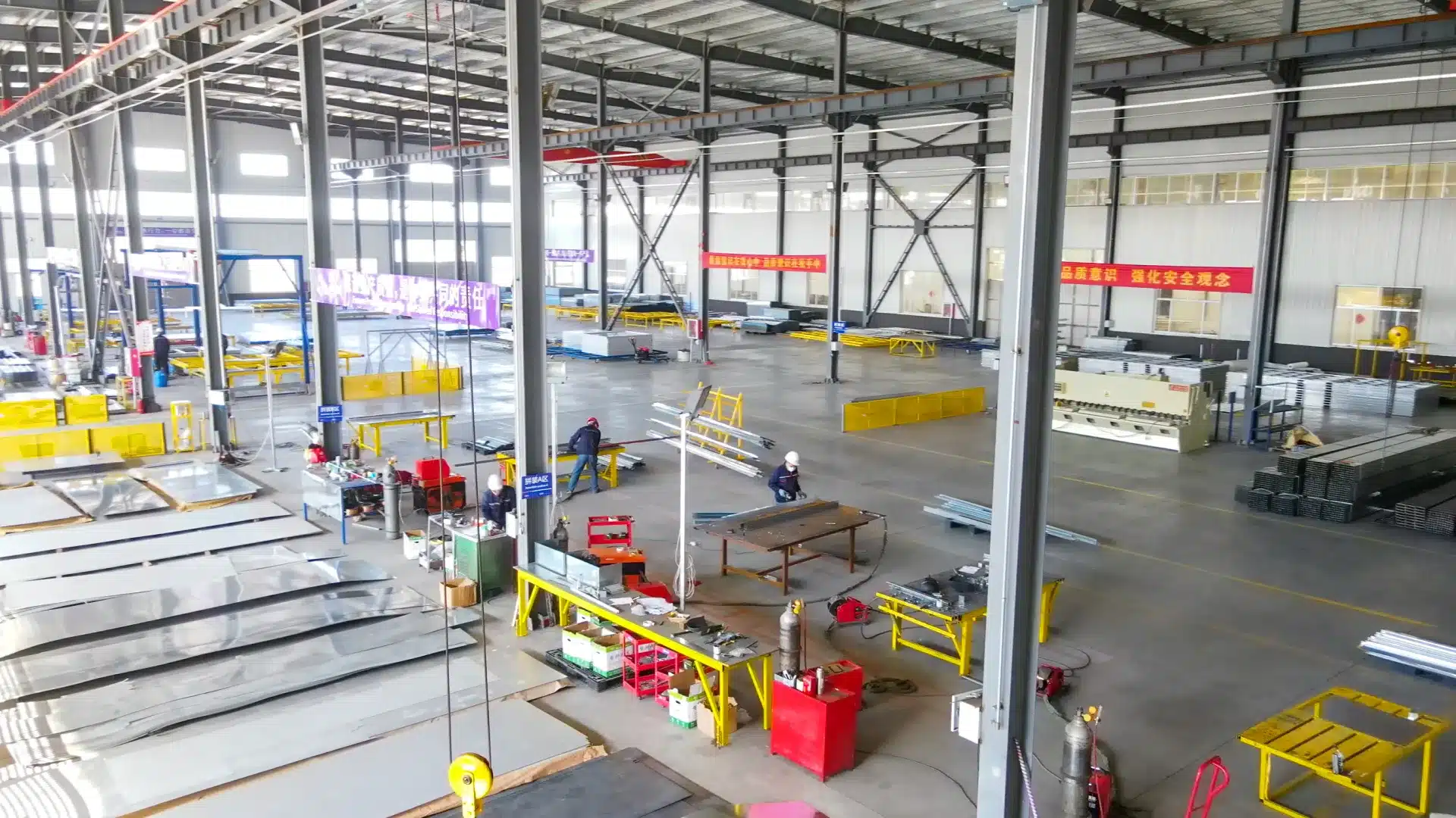 Industrial facility manufacturing flat pack steel storage containers with components and finished units.