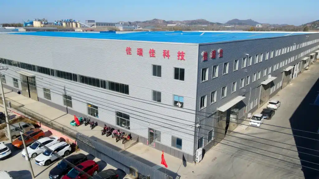 Flat pack steel container manufacturing facility with assembled storage unit and production components.