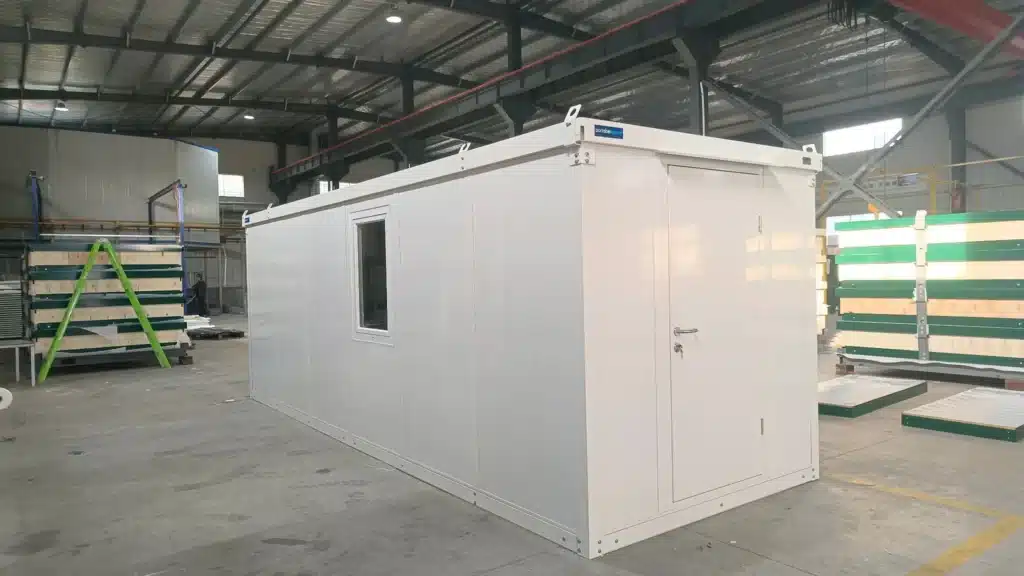 inished steel shipping container office at a commercial construction site, illustrating the cost of building a functional workspace.