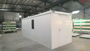 inished steel shipping container office at a commercial construction site, illustrating the cost of building a functional workspace.